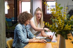 Two women discussing at a laptop